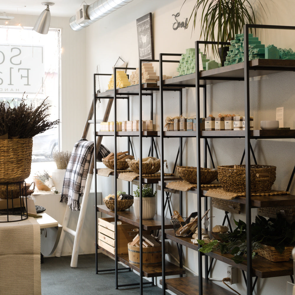 Interior of the Soap & Flame shop, view down a shelf lined with handcrafted soap bars.