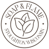 A circular brown logo emblem with the words 'SOAP & FLAME' around the top and 'STOUGHTON WISCONSIN' around the bottom, featuring a simple leaf illustration in the center on a white background.