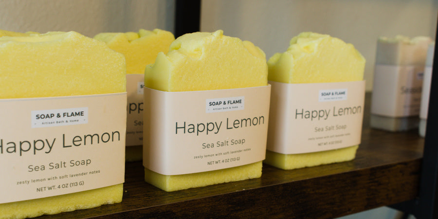 Bars of 'Happy Lemon' sea salt soap on a shelf.