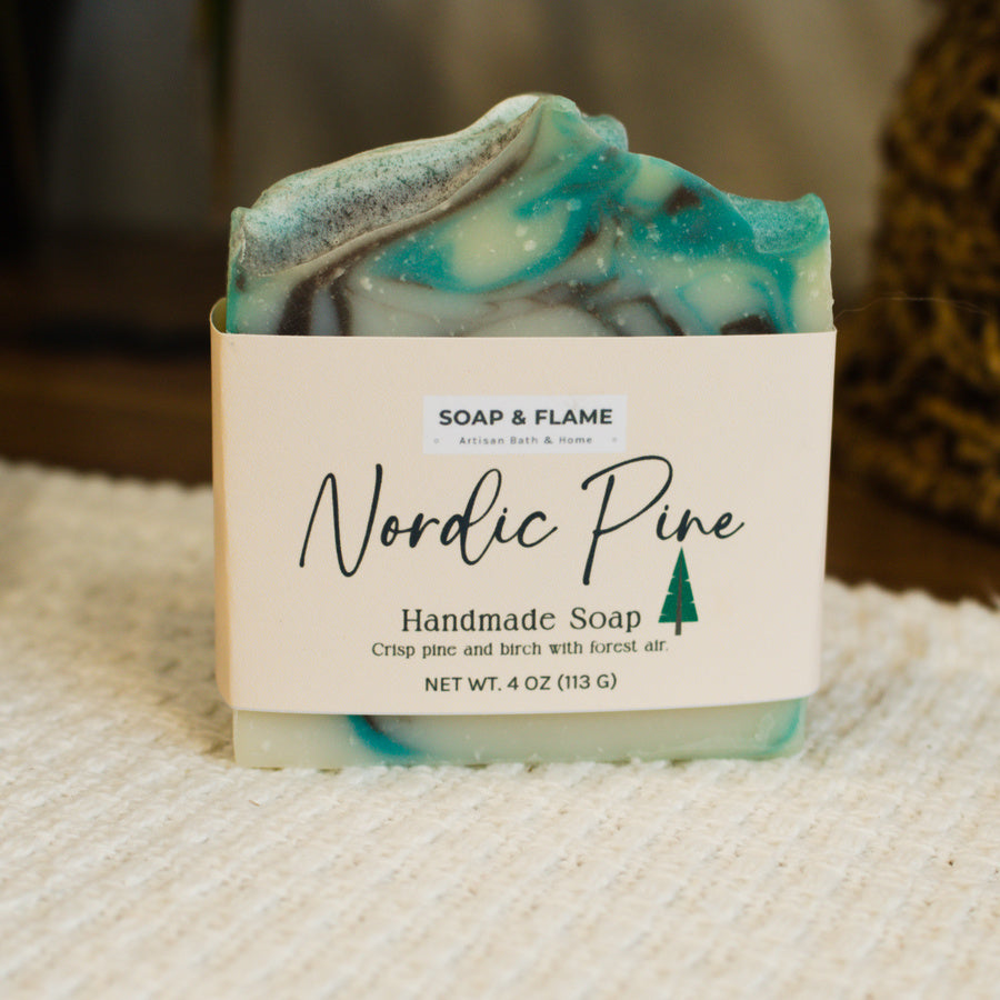 Handmade soap bar with 'Nordic Pine' label on a textured surface