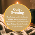 Quiet Evening Handcrafted Soap scent infographic: a lit candle and a steaming mug beside a linen blanket in warm, dim light, with text reading Quiet Evening, Top Notes: Ambrette Seeds, Middle Notes: Cyclamen, Muskmallow, Musk Blossoms, Base Notes: Blonde Woods, Crystal Musk.