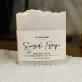 Bar of soap with 'Seaside Escape' label on a textured surface