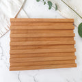 Red Alder Wooden Soap Dish: a slatted red alder wood soap dish shown in a simple flat lay against a light background.